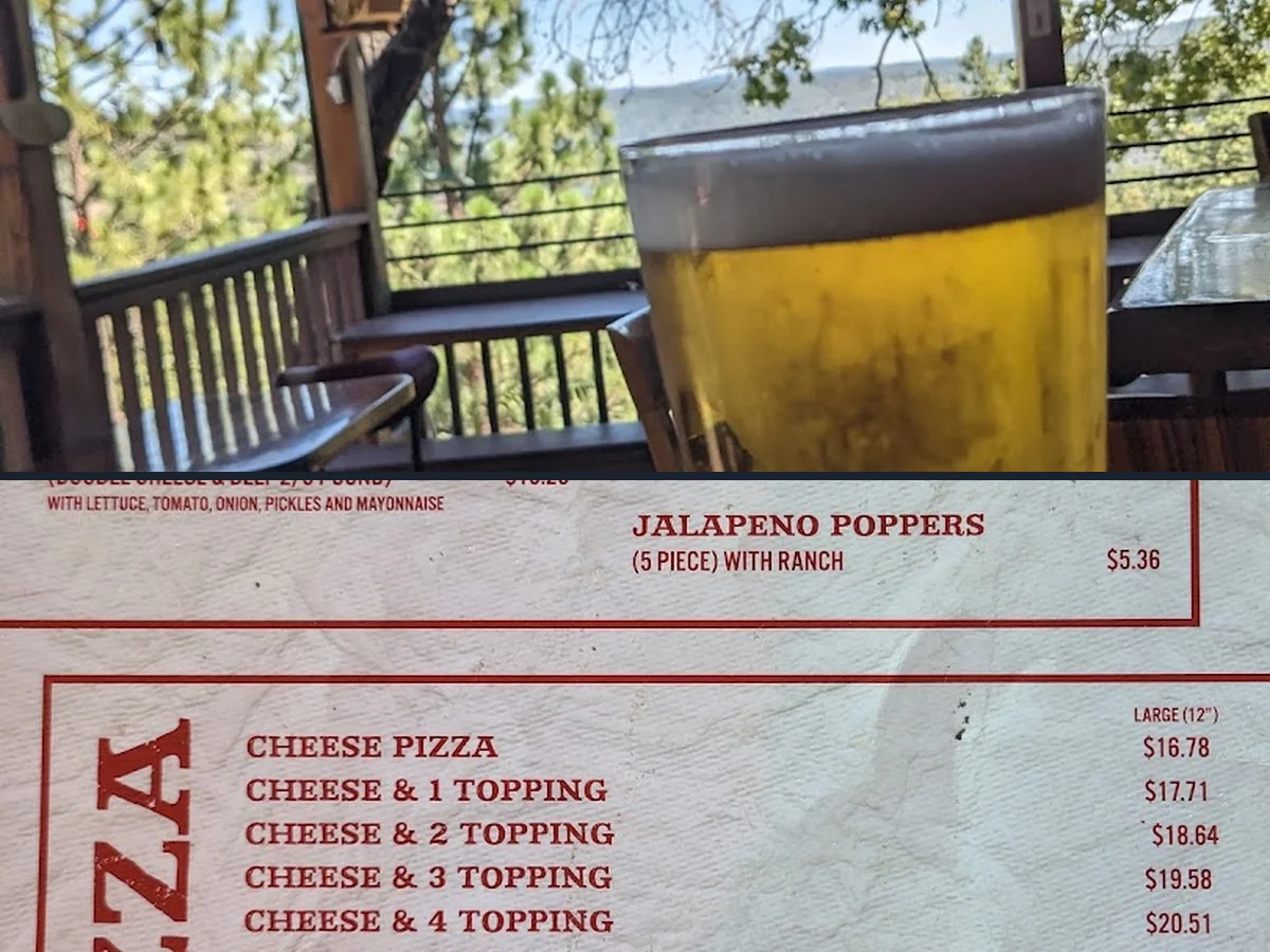 Pizza and burgers served on simple plates.