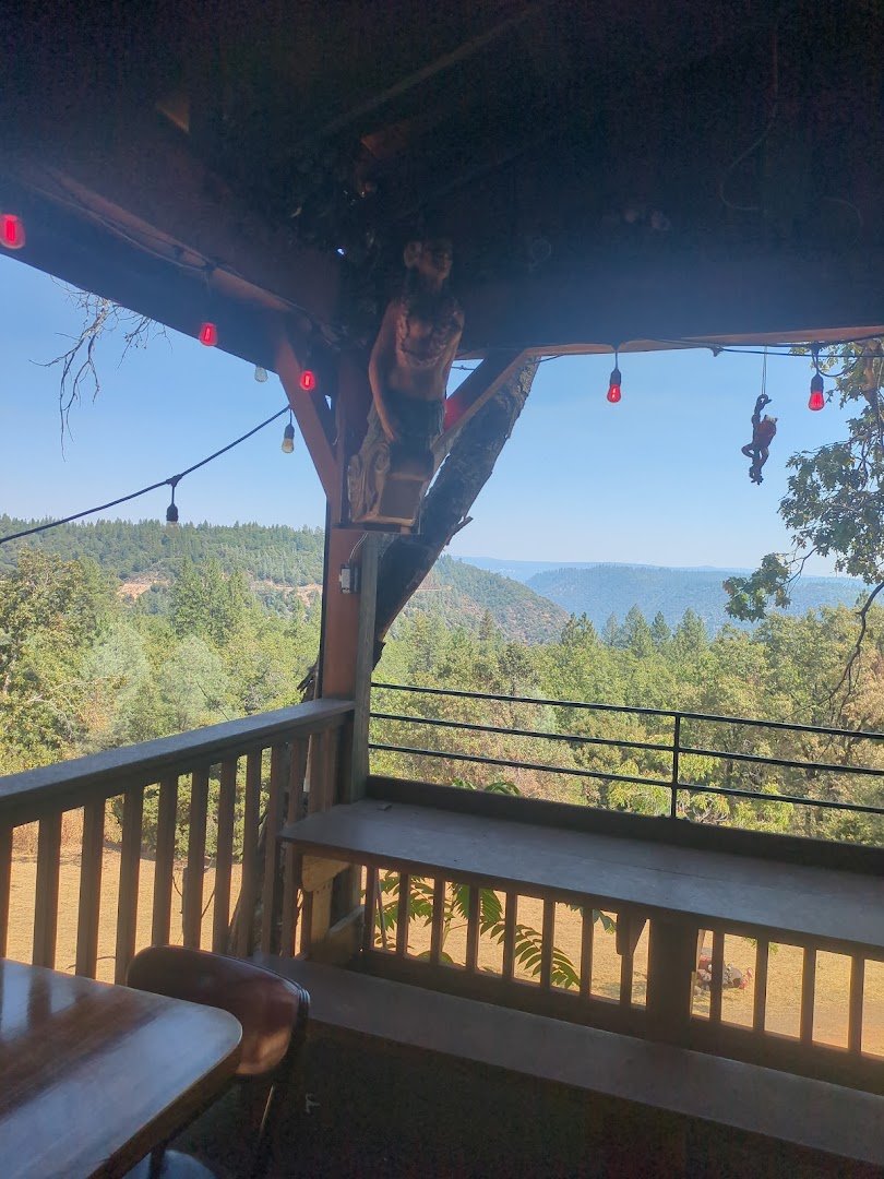 Outdoor patio with a view beyond the railing.